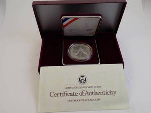 lot 95 image: 1988 Proof Silver Dollar US Olympic With Certificate of Authenticity In Box In Felt Box