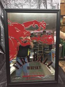 lot 44 image: Fireball Cinnamon Whisky. Tastes like Heaven, Burns like Hell, mirror