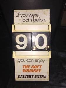 lot 91 image: Calvert Whiskey calendar with plastic date cubes