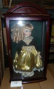 Porcelain doll in glass and wood ca...