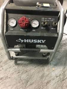 lot 202 image: 4.5 Gal. Portable Electric-Powered Silent Air Compressor by Husky in working conditions