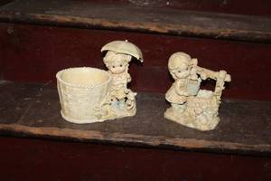 lot 208 image: Lot of (2) Porcelain Table Figurines - Girl with Umbrella Next To Wicker Basket, Girl At Water Well
