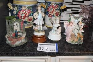 lot 272 image: Lot of (4) Ceramic Music Boxes - Prayer Clock, Colonial Man with Sheep, Two Birds, Angel Woman with Animals