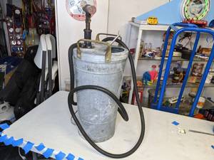 lot 1115 image: Tin Canister with Hand Pump and Hose