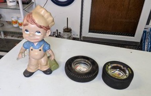 lot 1163 image: Two Vintage Tire Ashtrays (Goodyear and Seieerling) & Ceramic Mechanic Boy Statue