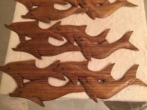 lot 100 image: Four Carved Dolphins