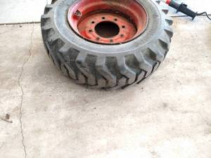 lot 19 image: Skid Loader Tire with Rim, 10-16.5...