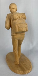 lot 2 image: Hand Carved Folk Art Man Hiking Sculpture