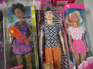 lot 110 image: 9 Barbies and a wooden Barbie set...
