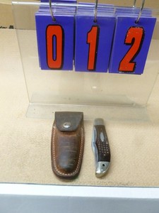 Case vintage knife with leather case on spring back. As shown.