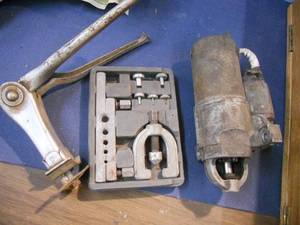 lot 78 image: Brake Line Flange Kit, Motorcycle Kickstand, Starter Core (Unknown Condition)