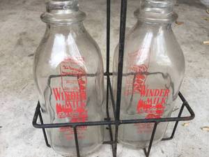 lot 105 image: Vintage Winder Milk Bottles in Wire Carrier