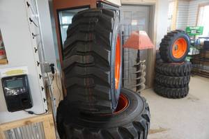 lot 5 image: Brand New Set of 4 - Tour Track Heavy Wheel Rim Guard 14 Ply Skid Loader Tires and 8 Bolt Rims
