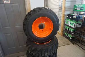lot 6 image: Brand New Set of 4 - Tour Track Heavy Wheel Rim Guard 14 Ply Skid Loader Tires and 8 Bolt Rims