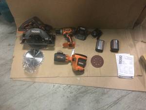 lot 103 image: RIDGID R92163SBN 18 Volt Cordless 3 Power Tool Combo Kit DrillDriver Saw Sander in good conditions