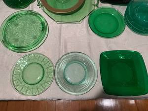 Variety of green glass plates and serveware