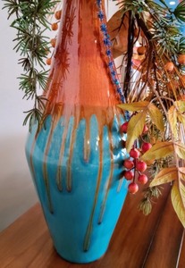 lot 71 image: Tall Decorative Vase With Faux Holiday Foliage