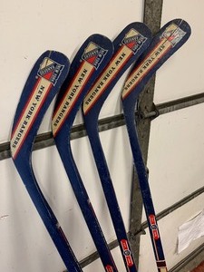 lot 174 image: Group of 4 NHL New York Rangers Hockey Sticks