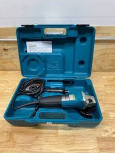lot 23 image: MAKITA 6 Amp 4 in. Corded Angle Grinder with Hard Case