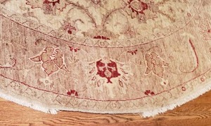 lot 50 image: Burgundy and Taupe Round Wool Area Rug