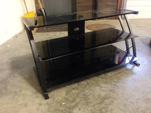 lot 32 image: 3 Tier Tempered Black Glass Media TV Console Stand - Great Condition - A little Dusty From Being In Storage