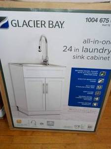 lot 67 image: All-in-One 24.125 in. x 21.375 in. x 35 in. Stainless Steel Laundry Sink with Faucet and Storage Cabinet by Glacier Bay- open box not used