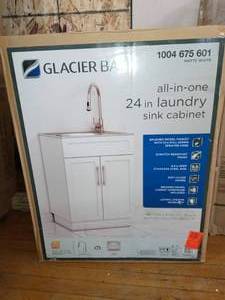 lot 69 image: All-in-One 24.125 in. x 21.375 in. x 35 in. Stainless Steel Laundry Sink with Faucet and Storage Cabinet by Glacier Bay- open box not used