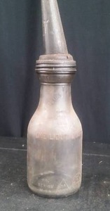 lot 97 image: ANTIQUE 1 LIQUID QUART GLASS WITH METAL SPOUT OIL JAR