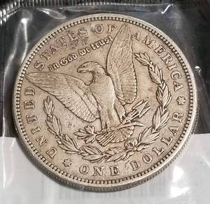 lot 28 image: 1885 MORGAN SILVER DOLLAR IN SEALED LITTLETON PACKAGE