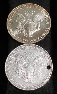 lot 45 image: 2 AMERICAN SILVER EAGLES 1 TROY OZ .999 FINE SILVER 1991 1996 (HOLED)