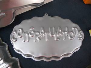 lot 56 image: New Cake Pan Molds - Congratulations, Haunted House, and Guitar