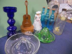 lot 93 image: Wooden Guitar Music Box, Clear Reamer Juicer, Green Depression Reamer Juicer, Woman Figure, Blue bottles with corks, Cobalt Blue Vase
