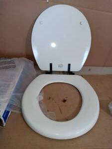 lot 22 image: Weston Never Loosens Round Closed Front Toilet Seat in White with Oil Rubbed Bronze Metal Hinge by BEMIS- open box not used