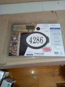lot 53 image: Classic Black Cast Aluminum Oval Address Plaque - open box not used