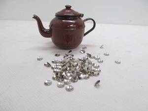 Metal teapot, thumbtacks
