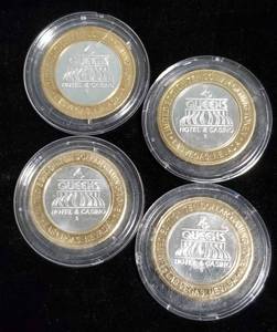 GROUP OF 4 CASINO TOKENS IN AIRTITES