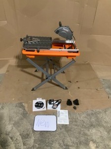 lot 12 image: New Ridgid 9 amp Corded 7 in. wet tile saw with stand