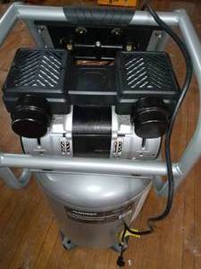 lot 61 image: 20 Gal. Vertical Electric-Powered Silent Air Compressor by Husky- loose screws
