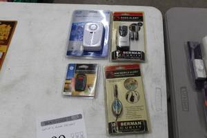 lot 189 image: Lot of (4) Alarm Systems (in package) - Mini Mobile Alert, GE Personal Security Pushbutton Keychain Alarm, Sabre Home Series Home Mode Elite Door Alarm, Bermen Shed Alert