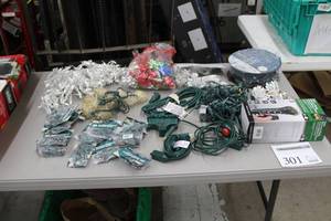 lot 301 image: Lot of Christmas Dcor (in package) - Multi Net LED 100-lamp, Extension Cords, Multi-Outlet Extension Cords, Replacement Holiday Bulbs 20-count, Ground Stake Countdown Timer, Misc. Light Strings, Pinecone Light String, Holiday Bows