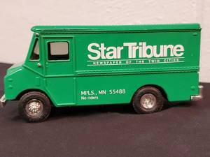 lot 129 image: (1) Retired Star Tribune Metal Coin Bank Truck