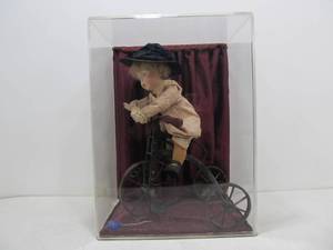 lot 24 image: Nice Hand Made Doll on Bicycle 