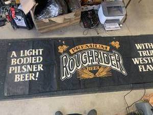 lot 80 image: Rough Rider Beer Sign  Banner (approx  2 12 x 8)