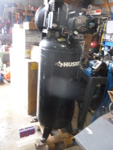 lot 1 image: Husky 60 gallon 220 volt air compressor. Juat removed from shop. Tested & works. Needs switch cover. As shown.