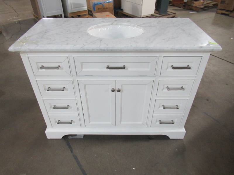 lot 100 image: Home Decorators Collection Windlowe 49 in. W x 22 in. D x 35 in. H Bath Vanity in White with Carrera Marble Vanity Top in White with White Basin 15101-VS49C-WT