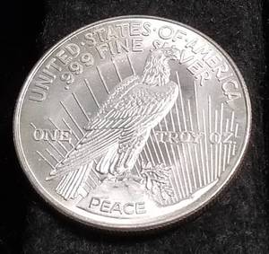 lot 37 image: 1 TROY OZ. .999 FINE SILVER PEACE DOLLAR DESIGN