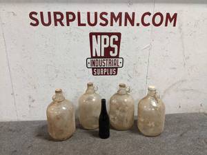 lot 39 image: (4) 1 Gallon Glass Jugs with Lids and Small Glass Bottle
