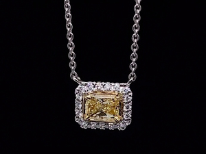 lot 3 image: Impressive .60 Carat Natural Fancy Yellow and White Diamond Radiant Cut Halo Necklace in 18k White Gold $10,500 Retail