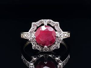 lot 85 image: Large Natural Ruby with Diamond Halo Estate Ring