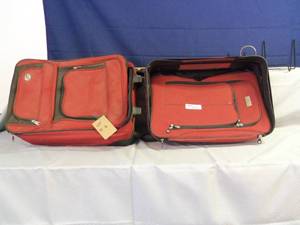 2 small red and black suit cases wi...